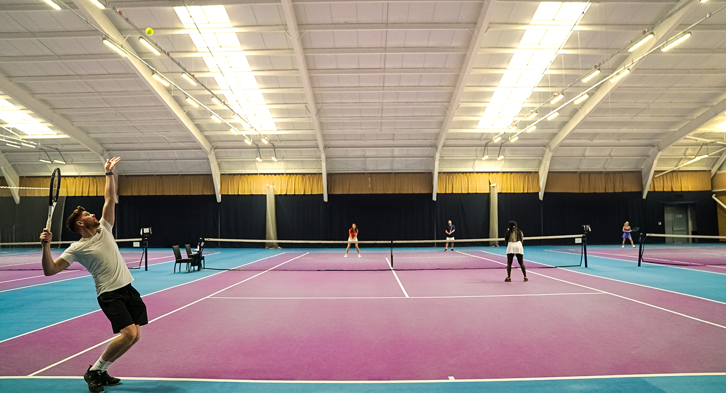 Image of people playing tennis at David Lloyd Clubs